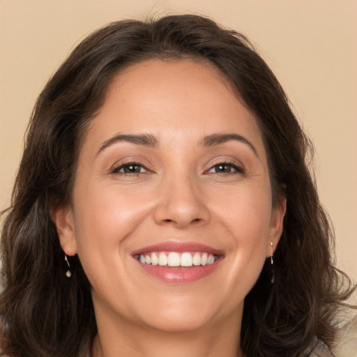 Joyful white adult female with long  brown hair and brown eyes