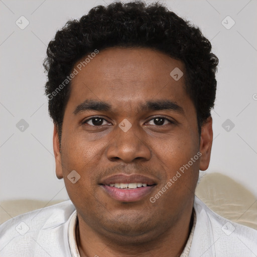 Joyful black young-adult male with short  black hair and brown eyes