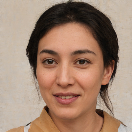 Joyful white young-adult female with medium  brown hair and brown eyes