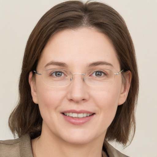 Joyful white adult female with medium  brown hair and grey eyes