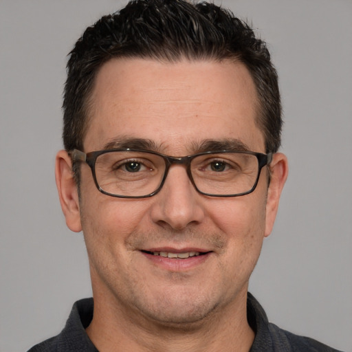 Joyful white adult male with short  brown hair and brown eyes