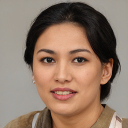 Joyful asian young-adult female with medium  brown hair and brown eyes