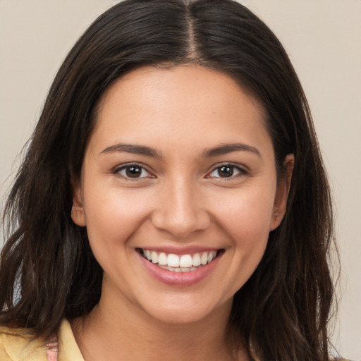 Joyful white young-adult female with long  brown hair and brown eyes