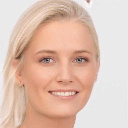 Joyful white young-adult female with long  blond hair and grey eyes