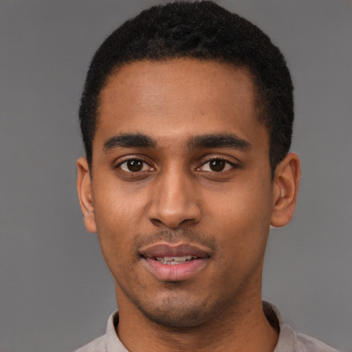 Joyful black young-adult male with short  black hair and brown eyes