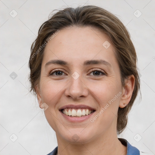 Joyful white young-adult female with medium  brown hair and grey eyes