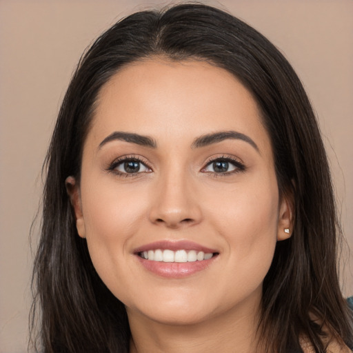 Joyful white young-adult female with long  brown hair and brown eyes