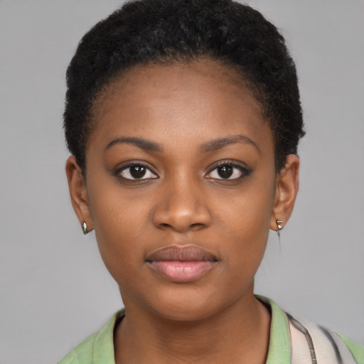 Joyful black young-adult female with short  brown hair and brown eyes