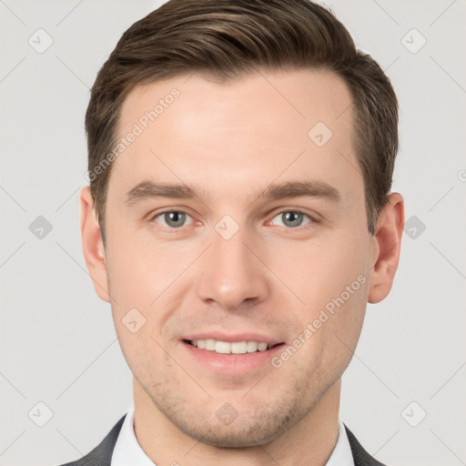 Joyful white young-adult male with short  brown hair and grey eyes