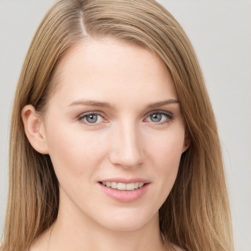 Joyful white young-adult female with long  brown hair and grey eyes