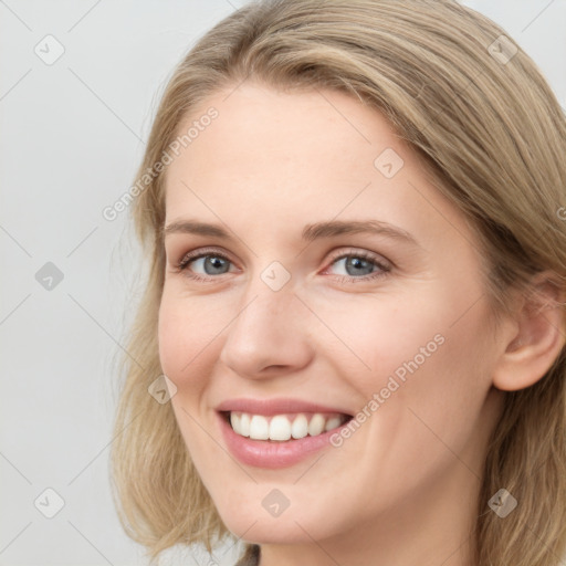 Joyful white young-adult female with long  brown hair and blue eyes