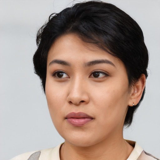 Neutral latino young-adult female with medium  black hair and brown eyes