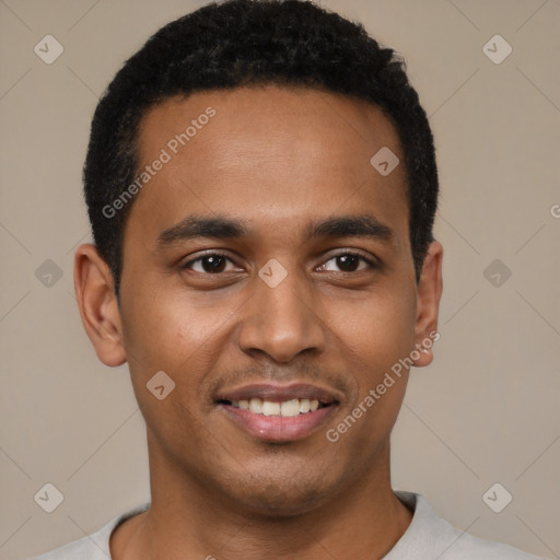 Joyful black young-adult male with short  black hair and brown eyes