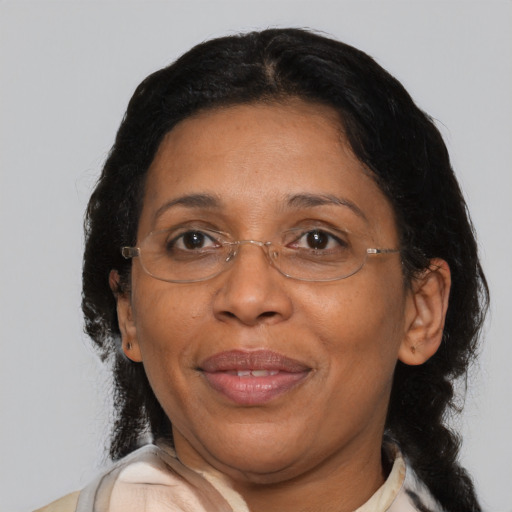 Joyful black adult female with medium  brown hair and brown eyes