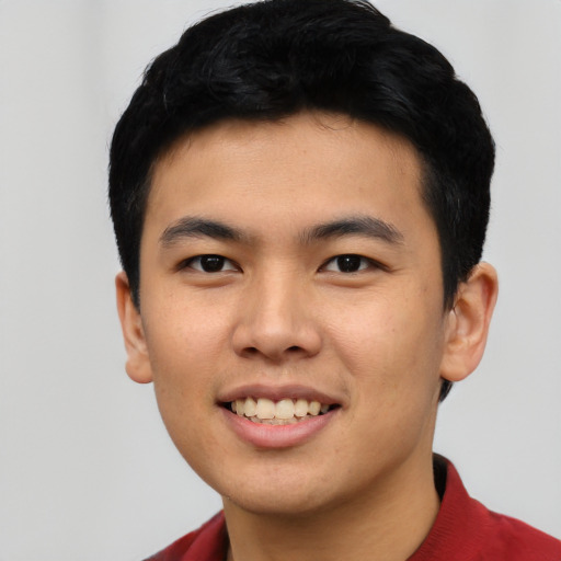 Joyful asian young-adult male with short  black hair and brown eyes