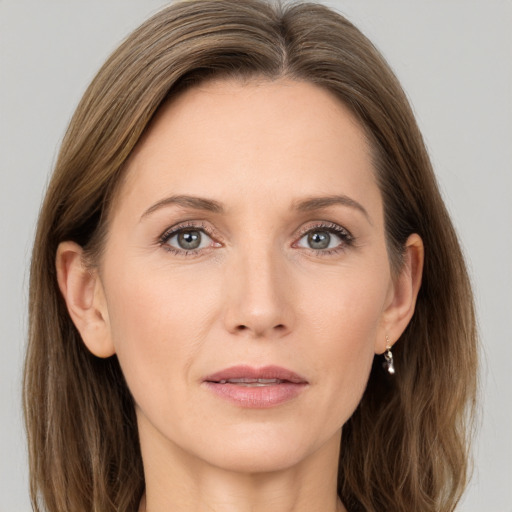 Joyful white adult female with long  brown hair and grey eyes