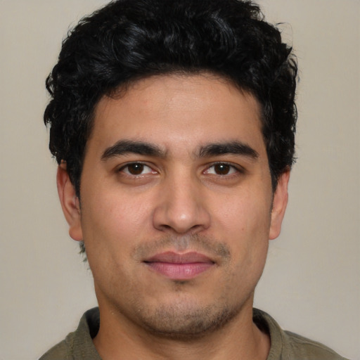 Joyful white young-adult male with short  black hair and brown eyes