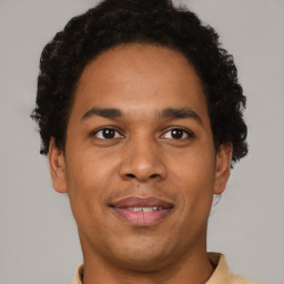 Joyful latino young-adult male with short  brown hair and brown eyes