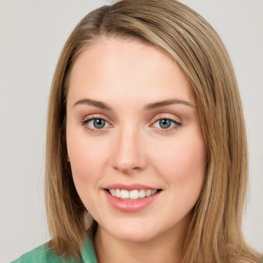 Joyful white young-adult female with long  brown hair and green eyes