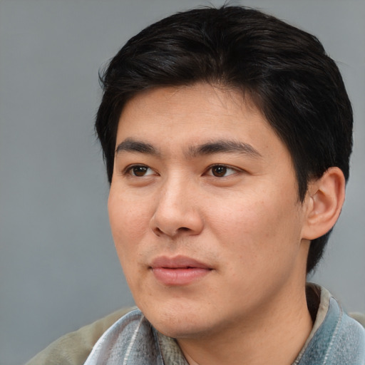 Joyful asian young-adult male with medium  brown hair and brown eyes