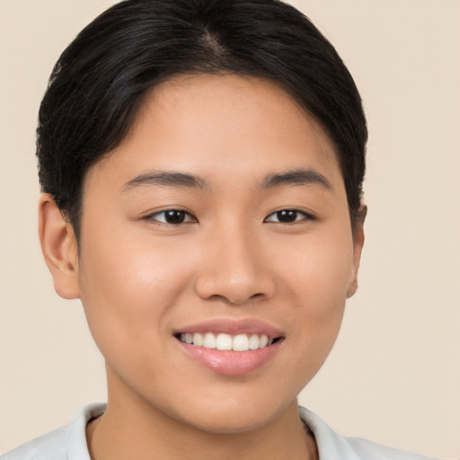 Joyful asian young-adult female with short  brown hair and brown eyes