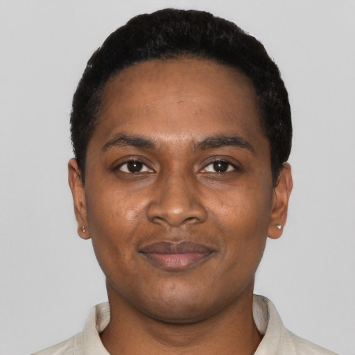 Joyful black young-adult male with short  black hair and brown eyes