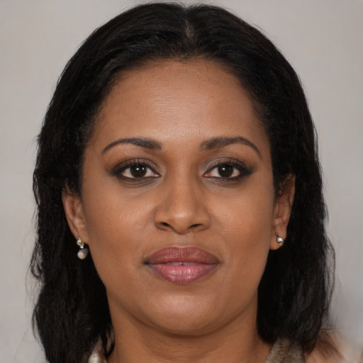 Joyful black adult female with medium  brown hair and brown eyes