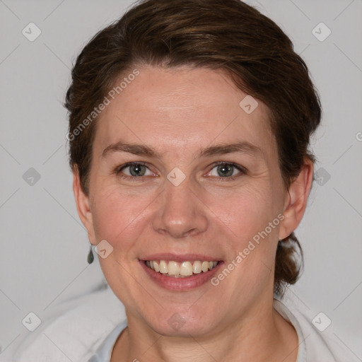 Joyful white adult female with short  brown hair and grey eyes