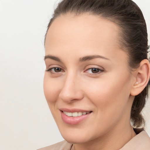 Joyful white young-adult female with medium  brown hair and brown eyes