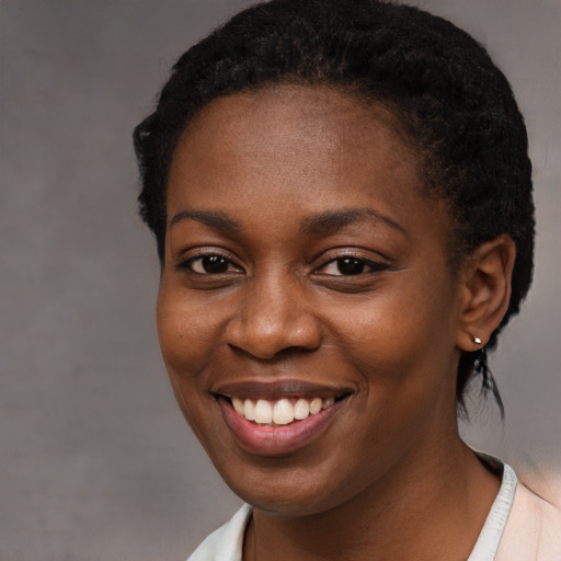 Joyful black young-adult female with short  brown hair and brown eyes