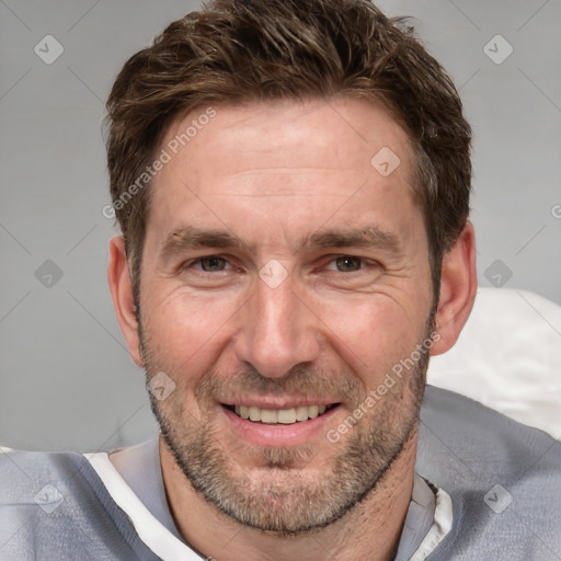 Joyful white adult male with short  brown hair and grey eyes