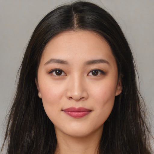 Joyful asian young-adult female with long  brown hair and brown eyes