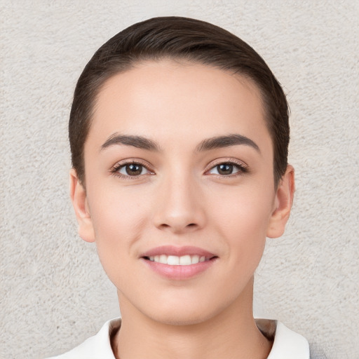 Joyful white young-adult female with short  brown hair and brown eyes