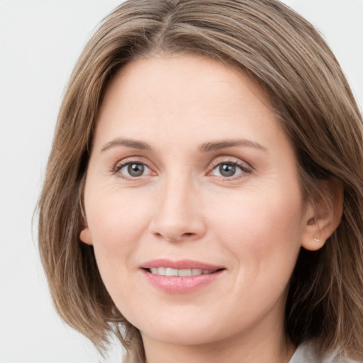 Joyful white young-adult female with long  brown hair and grey eyes