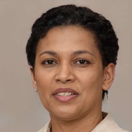 Joyful latino adult female with short  black hair and brown eyes