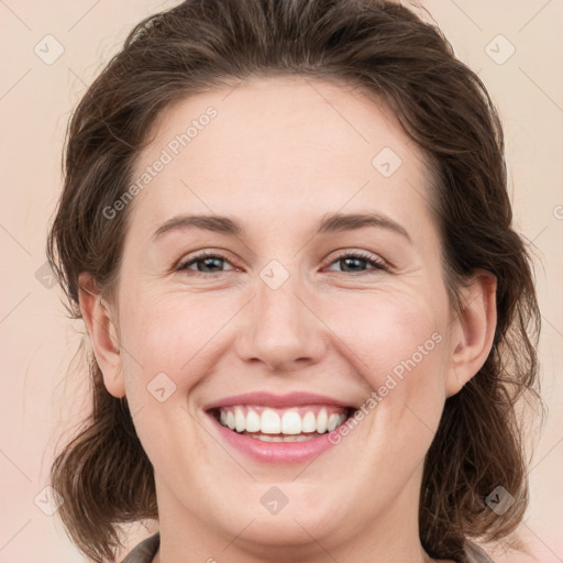 Joyful white young-adult female with medium  brown hair and green eyes