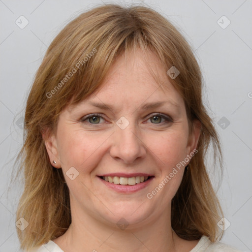 Joyful white adult female with medium  brown hair and grey eyes