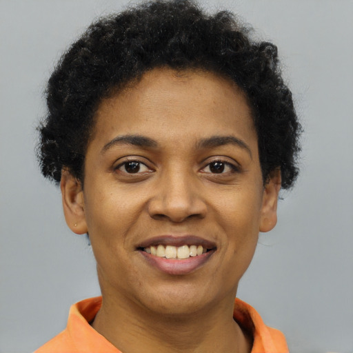 Joyful black young-adult female with short  brown hair and brown eyes