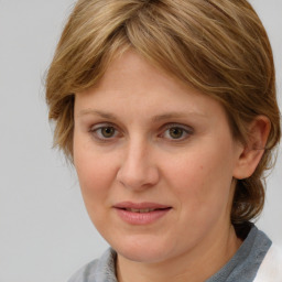 Joyful white young-adult female with medium  brown hair and blue eyes