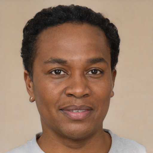 Joyful black adult male with short  black hair and brown eyes