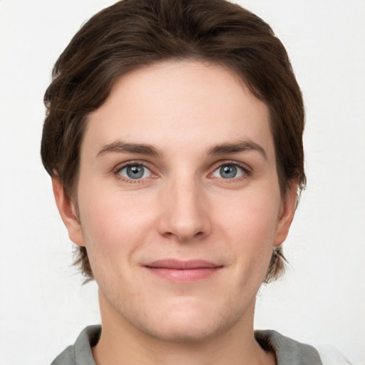 Joyful white young-adult female with short  brown hair and grey eyes