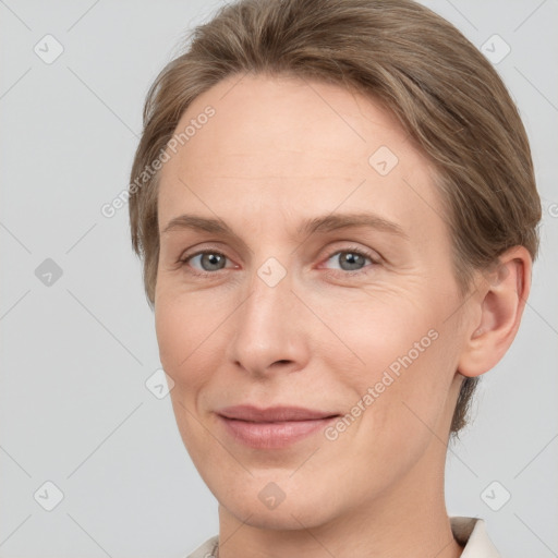 Joyful white adult female with short  brown hair and grey eyes