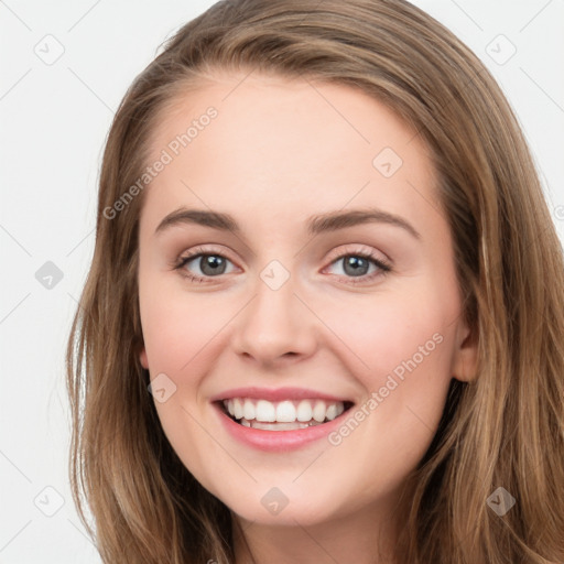 Joyful white young-adult female with long  brown hair and blue eyes