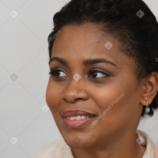 Joyful black young-adult female with short  black hair and brown eyes