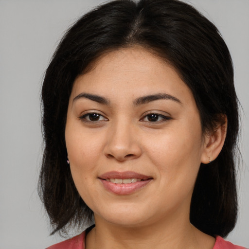 Joyful asian young-adult female with long  brown hair and brown eyes