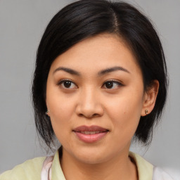 Joyful asian young-adult female with medium  black hair and brown eyes