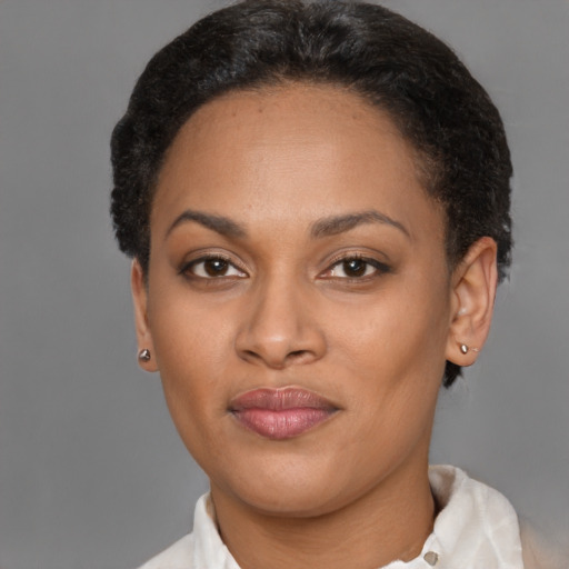 Joyful latino adult female with short  brown hair and brown eyes