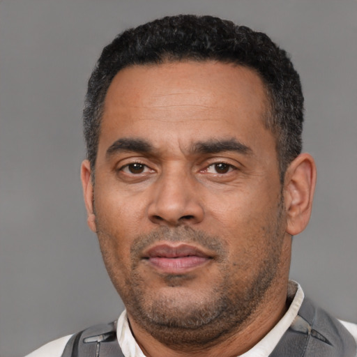 Neutral latino adult male with short  black hair and brown eyes