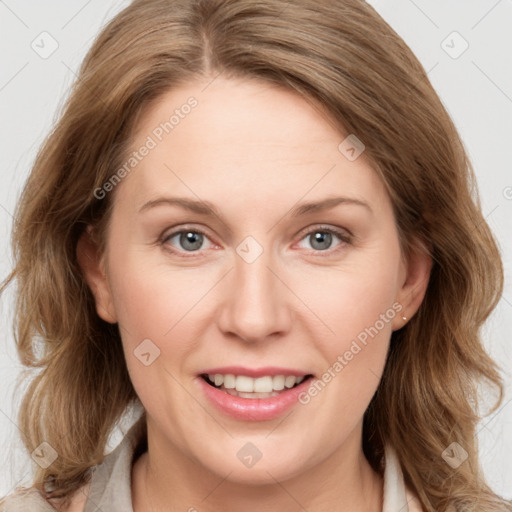 Joyful white adult female with medium  brown hair and blue eyes