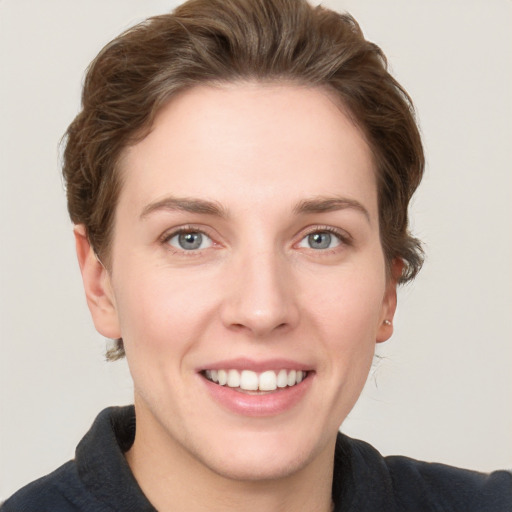 Joyful white young-adult female with short  brown hair and grey eyes